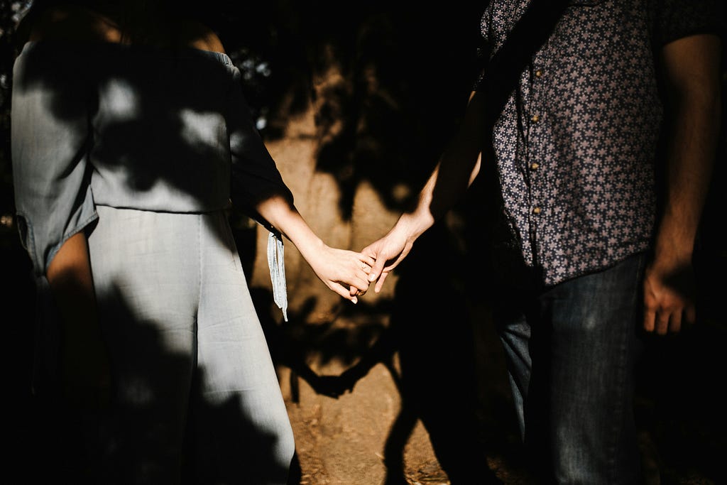 couples holding hands in shadows showing their will to stay together no matter what