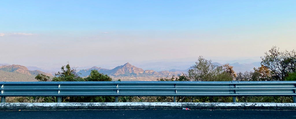 Road runs in parallel to the landscape, a metaphor for thought. Perspective of a mountain in the distance symbolizing vision