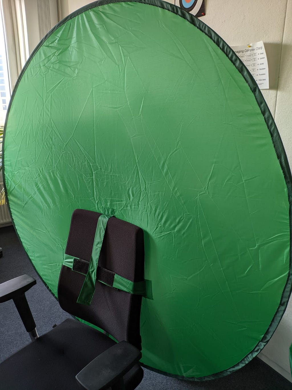 round green screen attached to an office chair using hook-and-loop fastener