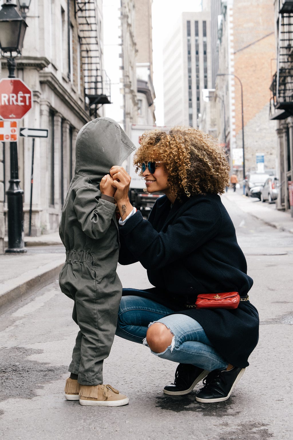 Mother listening to her child speak, with a smile on her face.