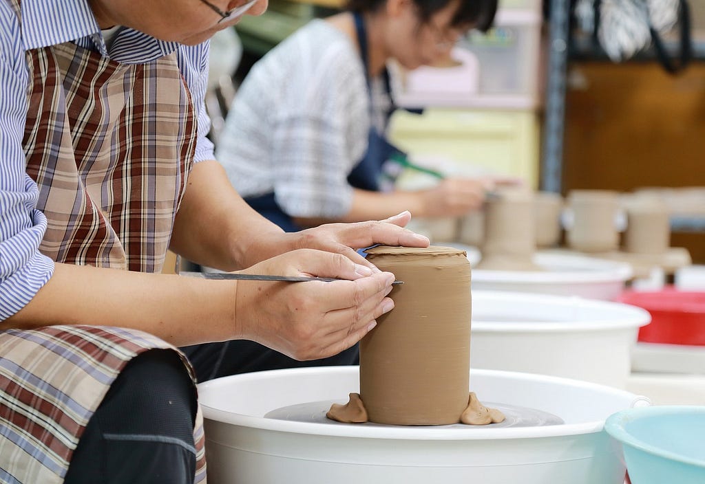 People working in a pottery class