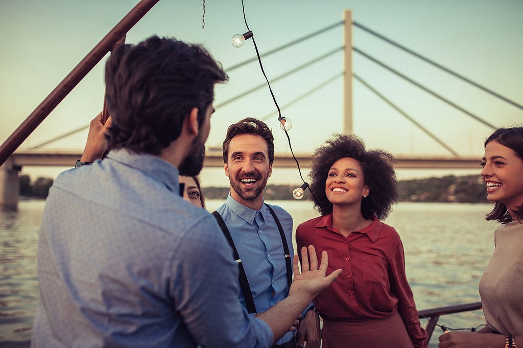 A man telling a story to an interested group of people.