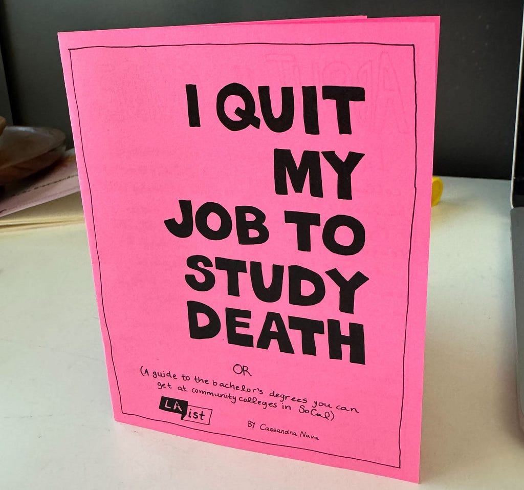 A pink stapled-booklet with text that reads “I quit my job to study death.”