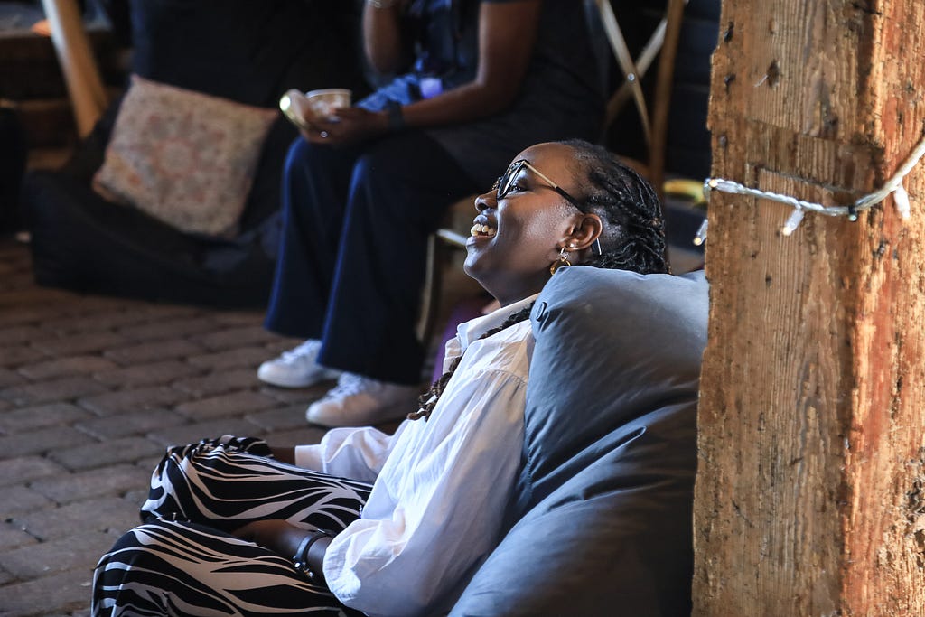 Guest sitting on a beanbag and smiling during the fireside chat.