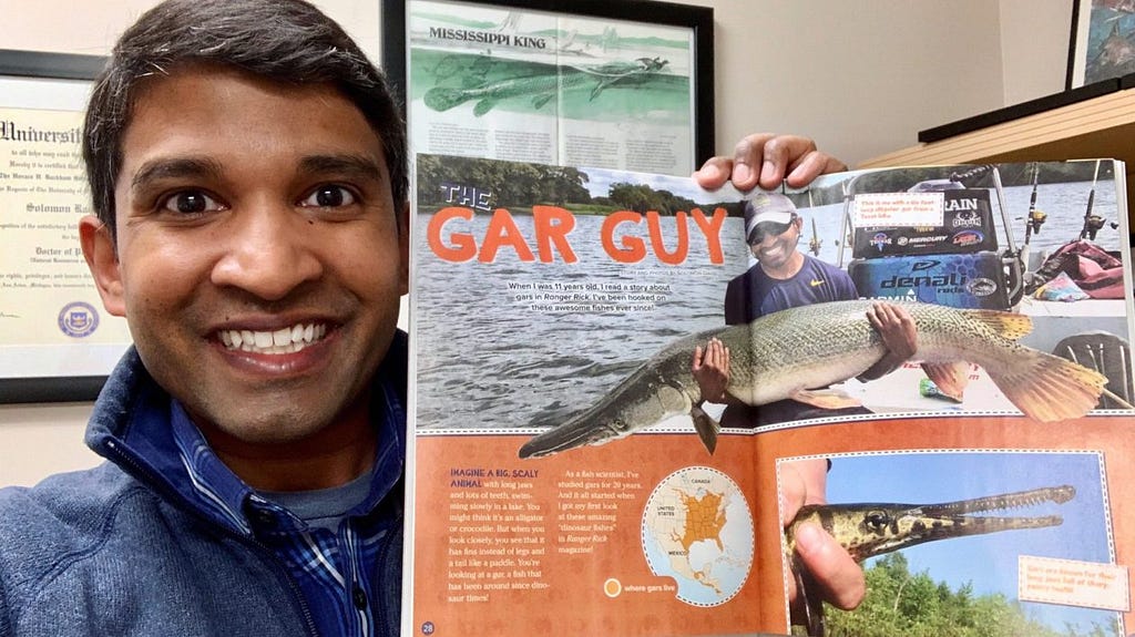 Solomon David holding up an issue of Ranger Rick featuring him and alligator gar