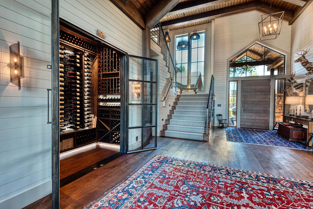 Glass, steel, wood & stone are the only materials used in this modern meets Mountain Lodge wine cellar by Sommi Wine Cellars.