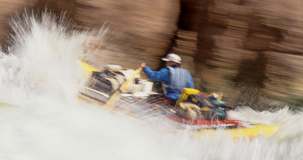 Rowing through whitewater in Grand Canyon.