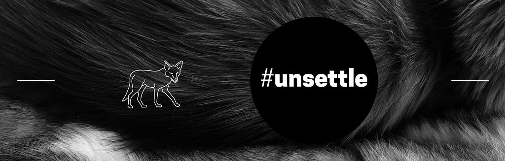 Background: Greyscale image of wolf fur. Foreground: white outlined wolf, black circular dot with word #unsettle.