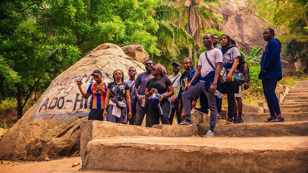 A group of people standing at the foot of Ado-Awaye hill