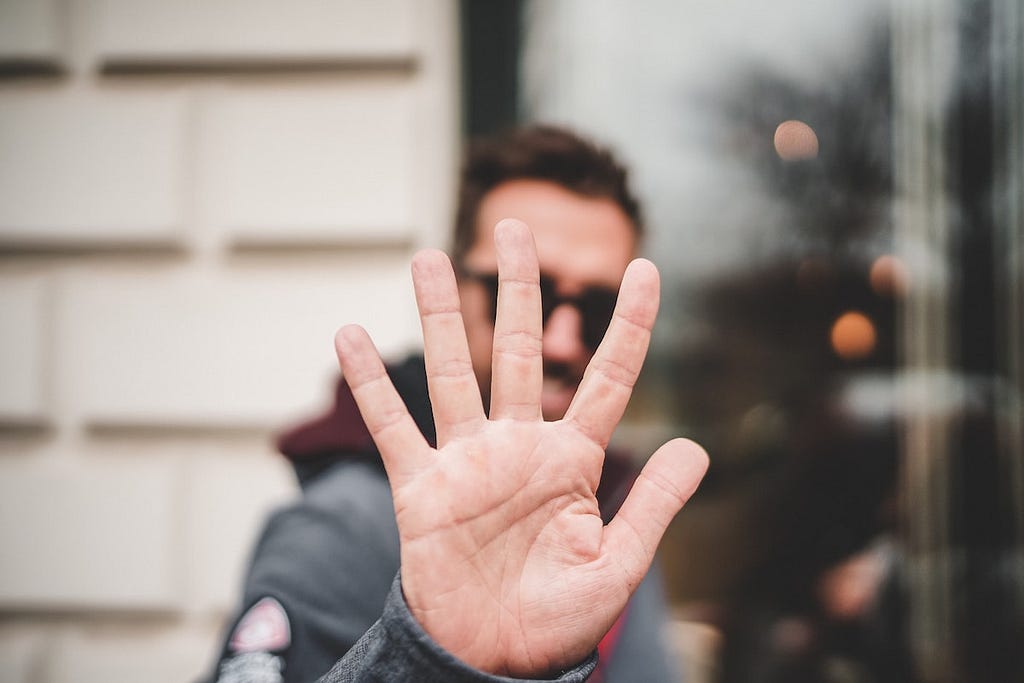 Guy holding up five fingers