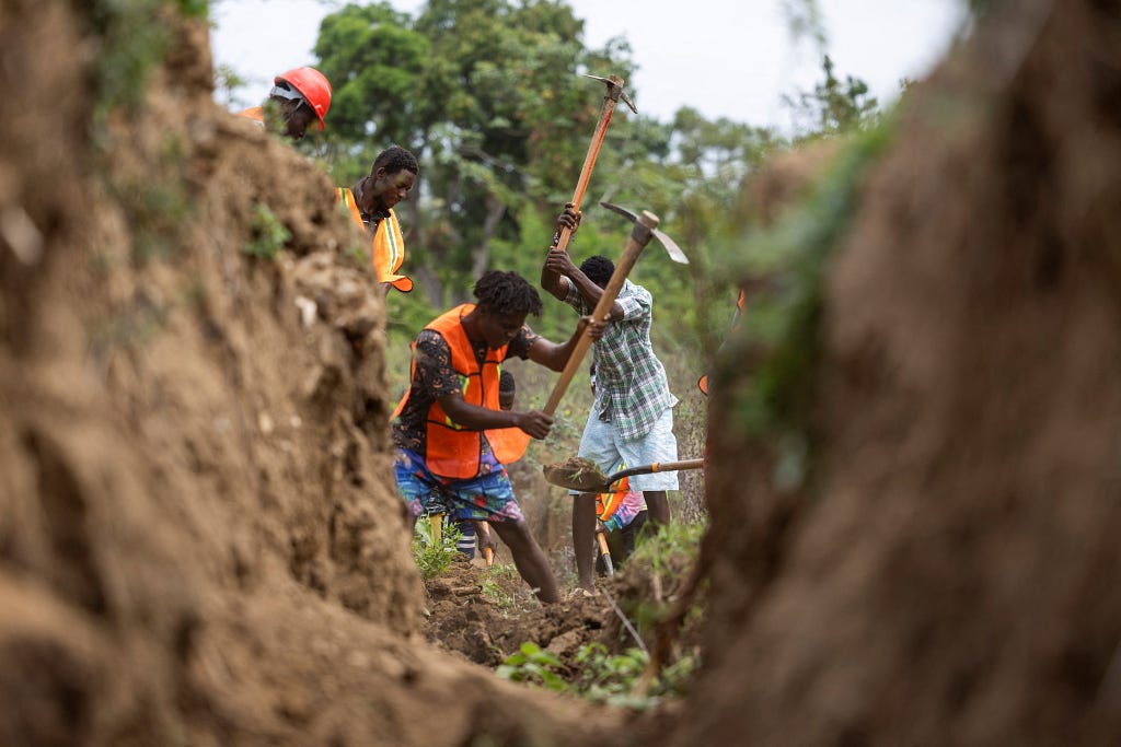 Residents of the Malfety neighborhood work on the construction of an irrigation canal in Fort Liberté, Haiti, April 27, 2024. Photo by Ricardo Arduengo/Reuters