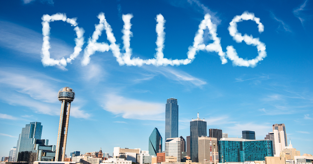 The Dallas skyline with “DALLAS” written in the clouds above.