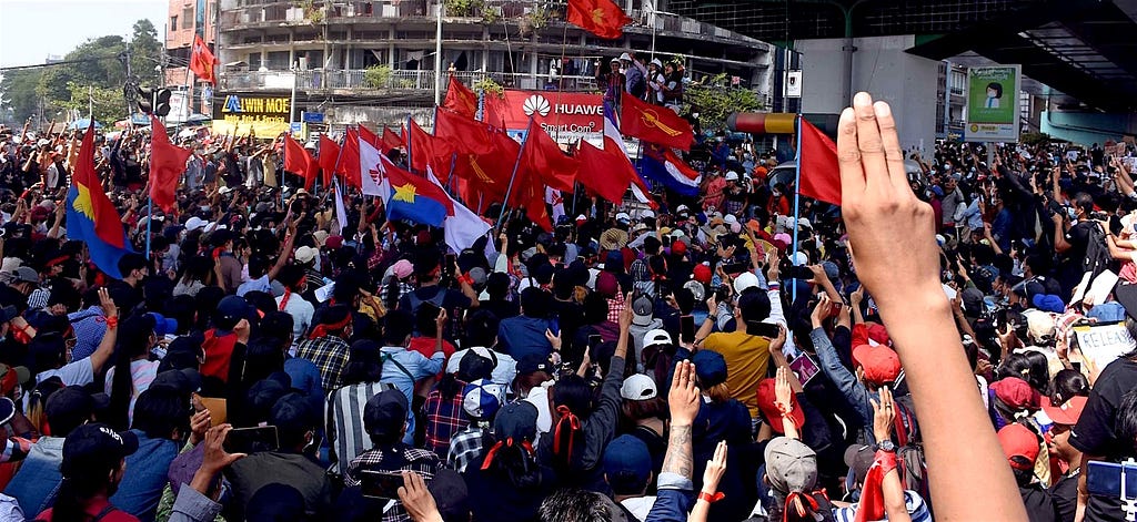 The three-finger salute in the foreground at a protest in Yangon, February 9, 2021.