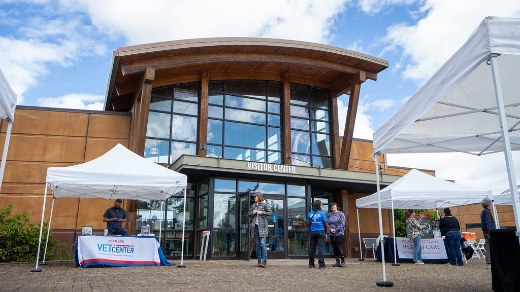 Photo of the visitors center at Tualatin River National Wildlife Refuge. There are event tents set up and people walking around.