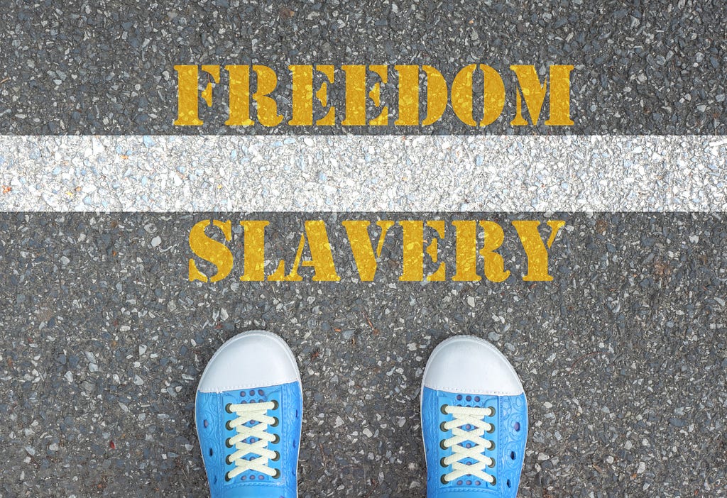 Banner showing someone in blue sneakers standing in front of a thin line between freedom and slavery