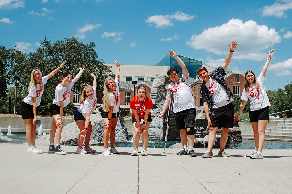 Brecken (center) smiles for a photo with incoming Huskers on either side of her