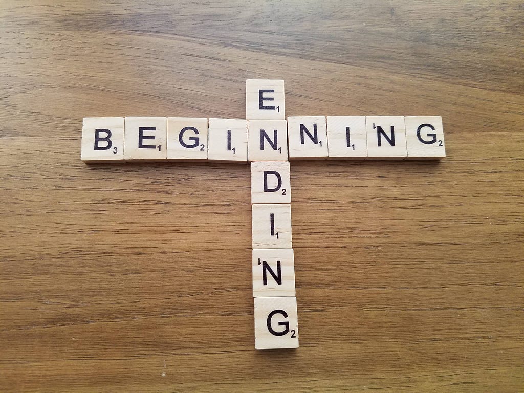 Wooden letters spelling out “beginning” (horizontally) and “ending” (vertically)