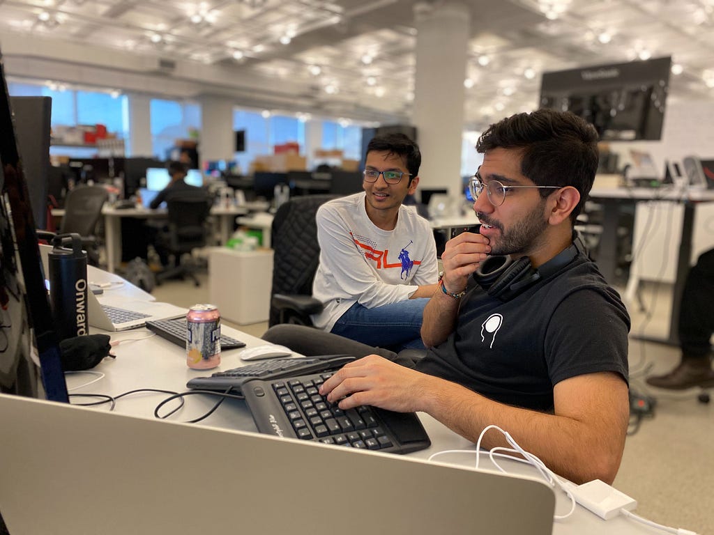 Two hackathon participants collaborate at their computer
