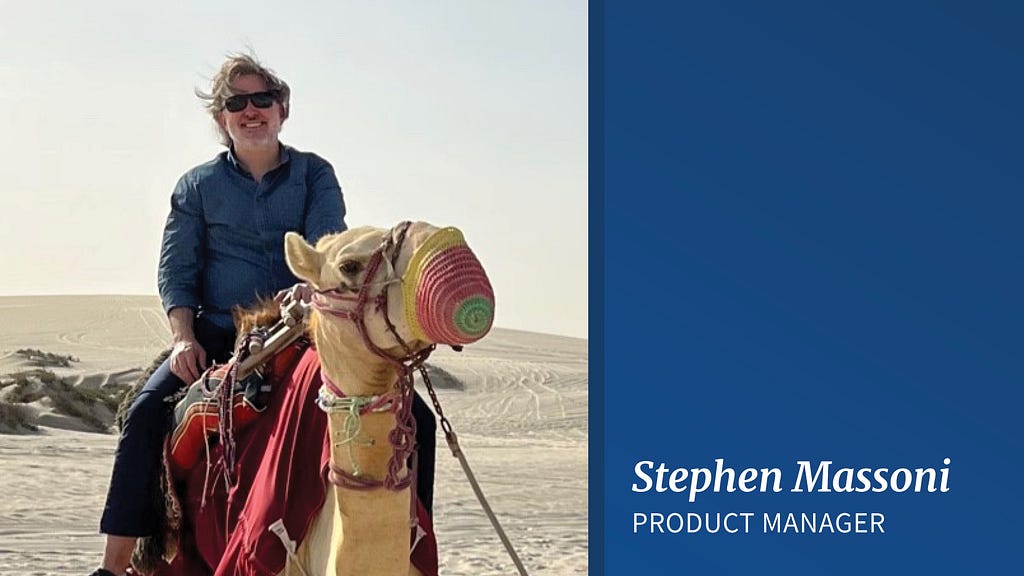 A man with brown, windswept hair and dark sunglasses sits on the back of a camel in the desert wearing a dark blue collared shirt and dark pants. On the right, white letters on a blue background read “Stephen Massoni, Product Manager.”