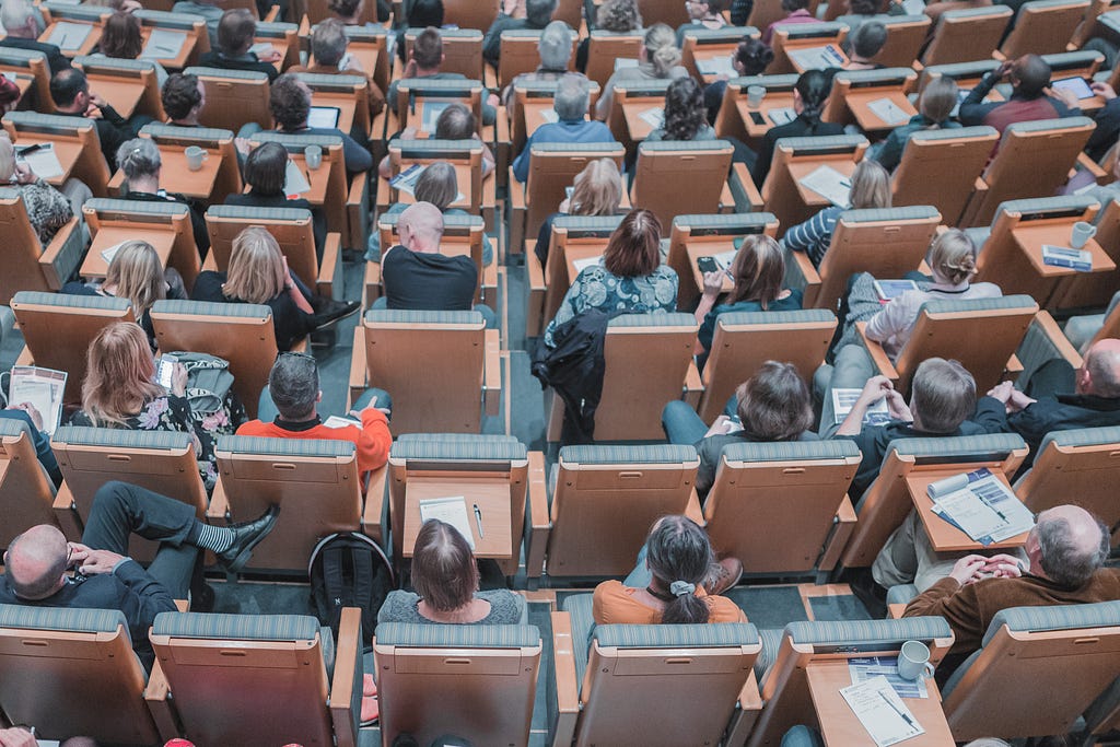 University classroom filled with people sitting on chairs