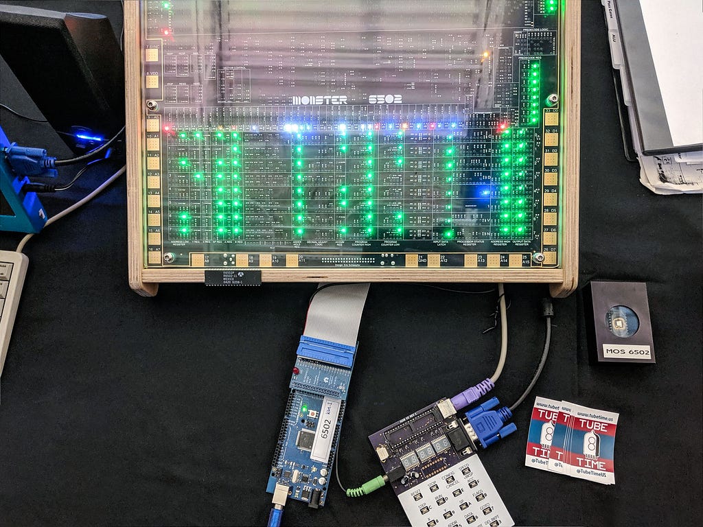 MOnSter 6502 connected to a RetroShield on a table. Lots of LEDs.