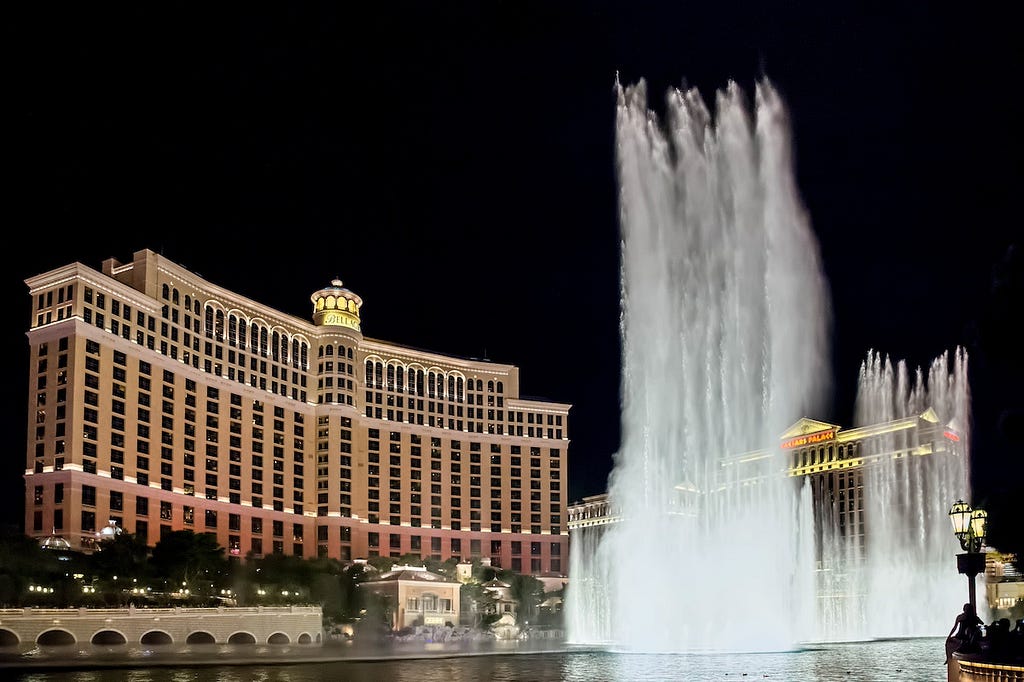 Fountain at night in Las Vegas with a casino in the background