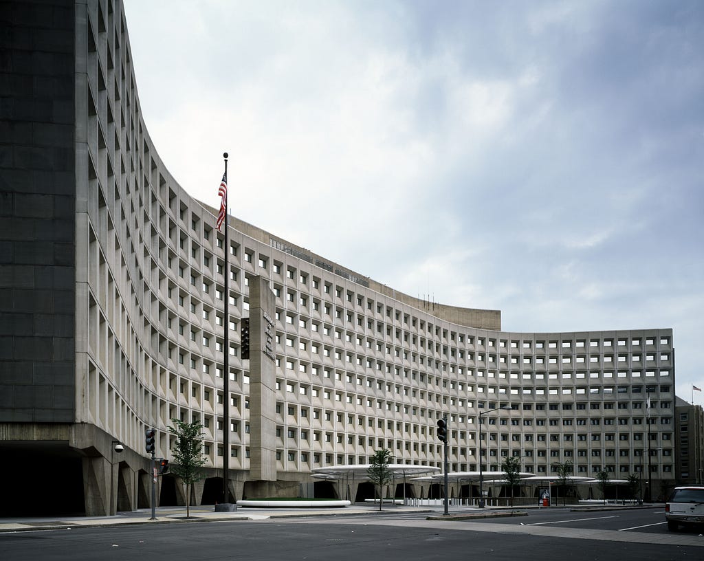 Robert C. Weaver Federal Building, U.S. Department of Housing and Urban Development. The building is white and symetrical and is lined with many identitcal windows.