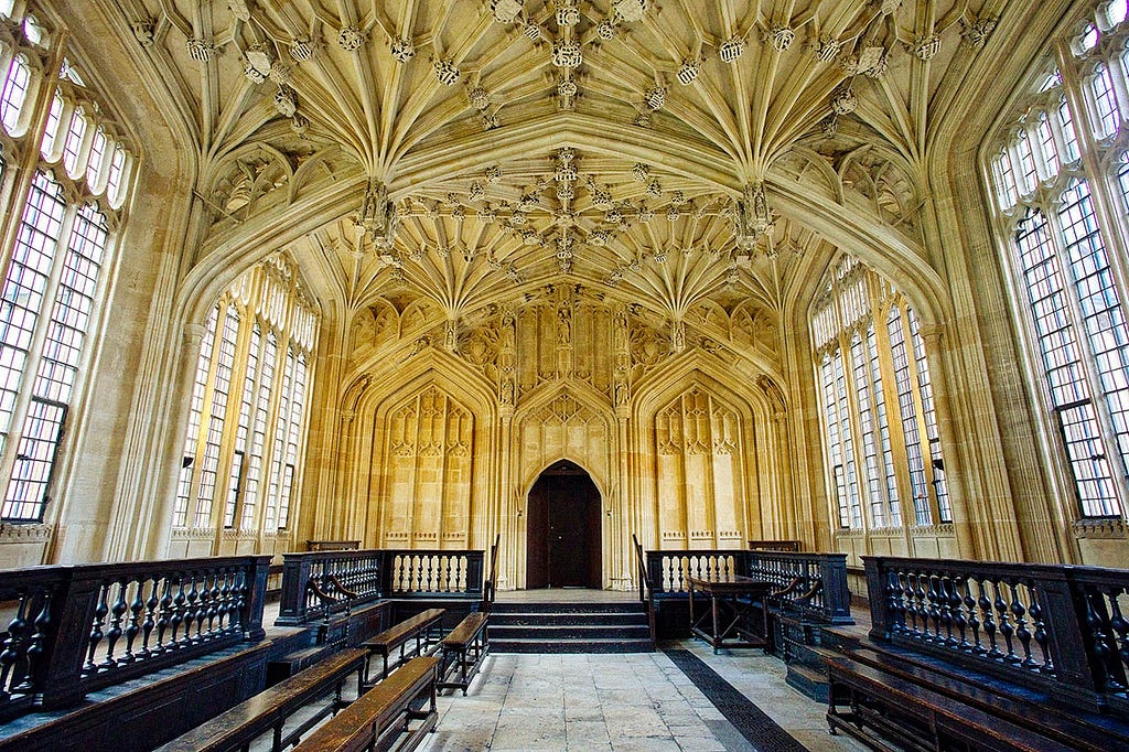 beautiful cloistered ceiling room with wooden bench seating