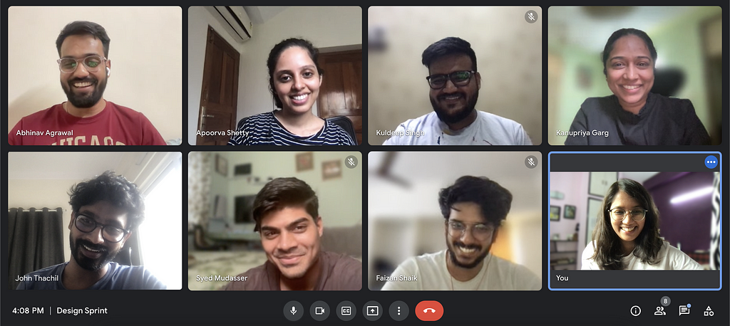 A screenshot of a Google meets meeting with 8 team members smiling