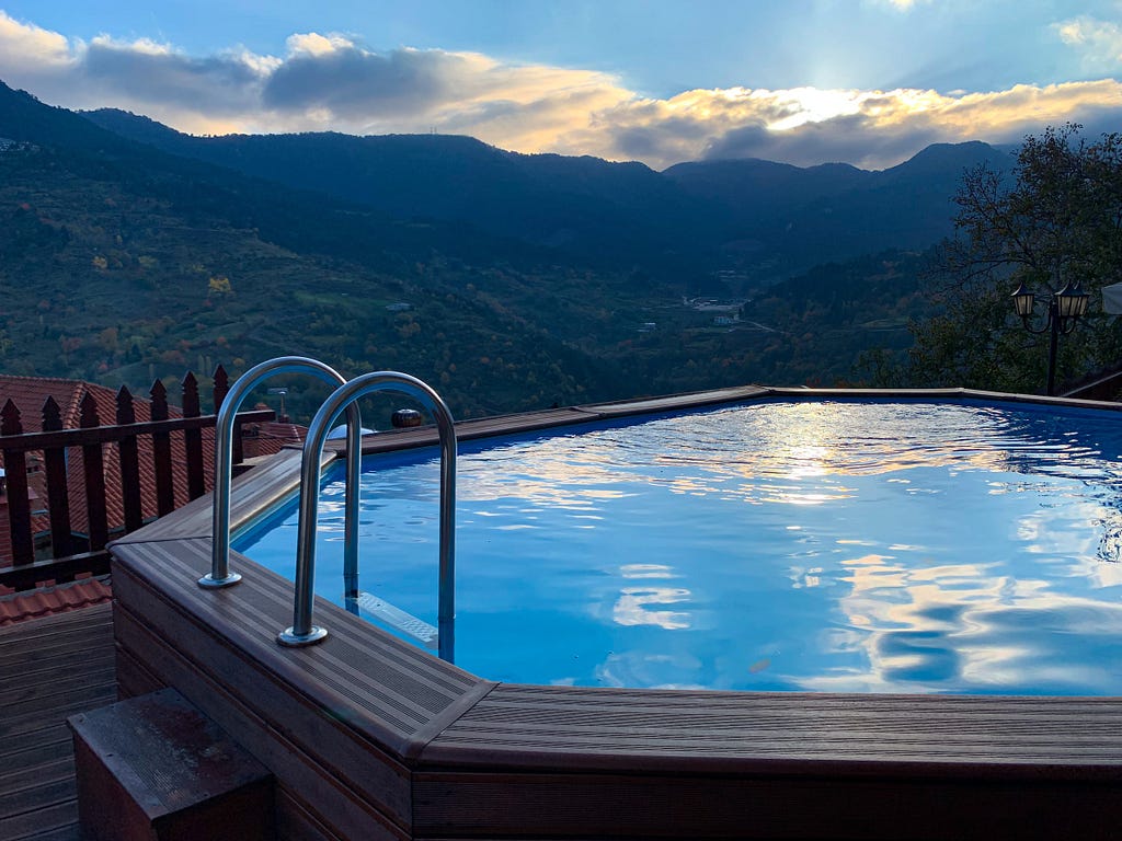 A hot-tub with a view across a green valley, from the side of hotel Archontiko at Metsovo village, Greece.