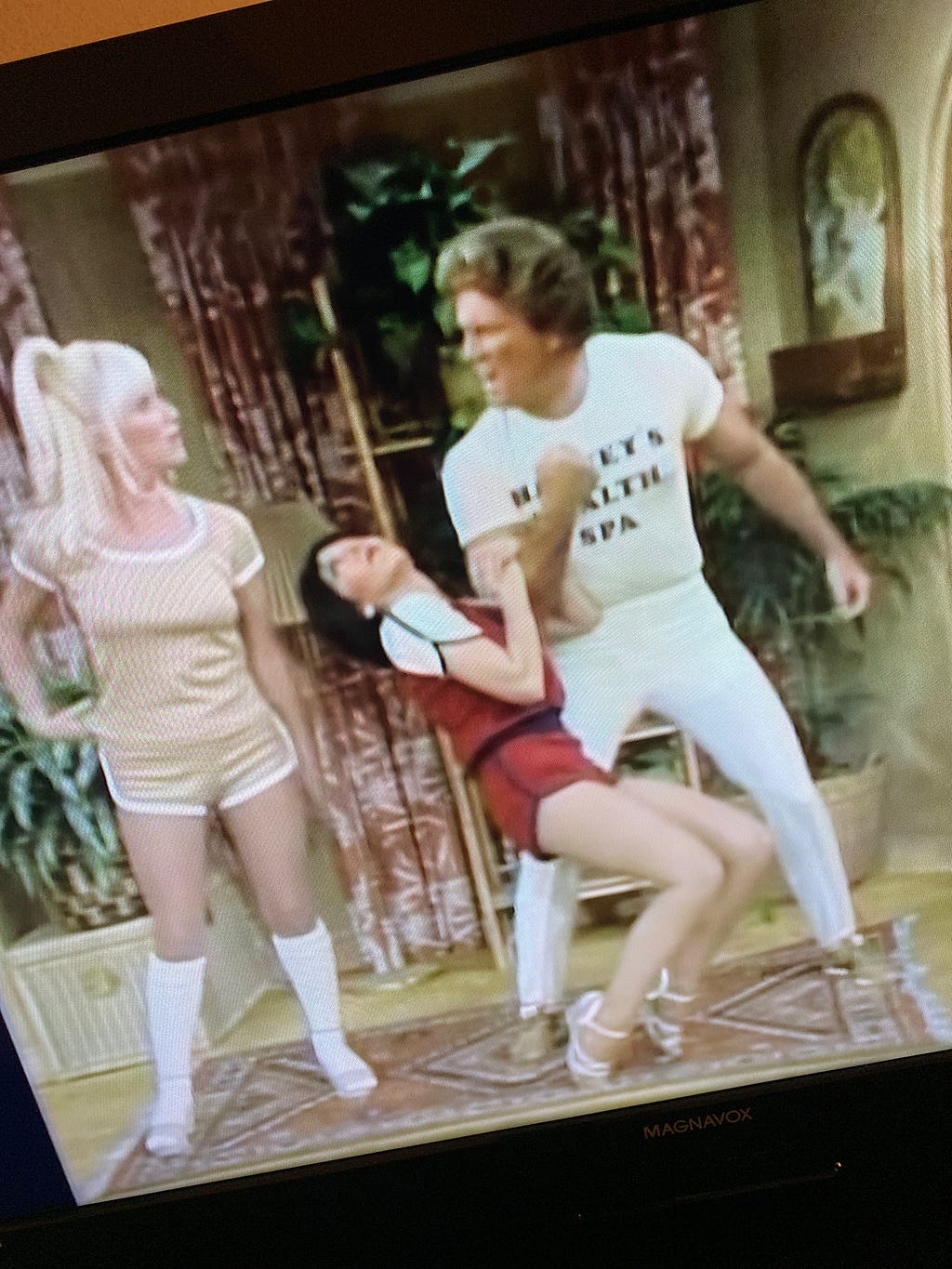 Chrissy and Janet with a fitness instructor in nineteen seventies fitness apparel shorts and t shirts