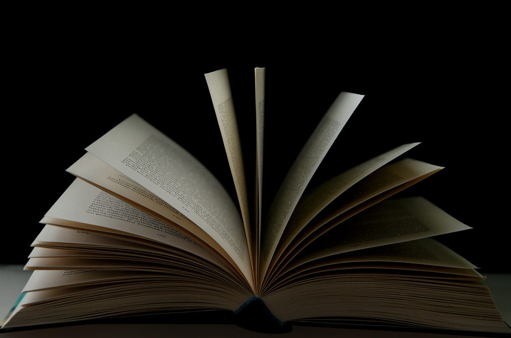 Photo of an open book on a black background