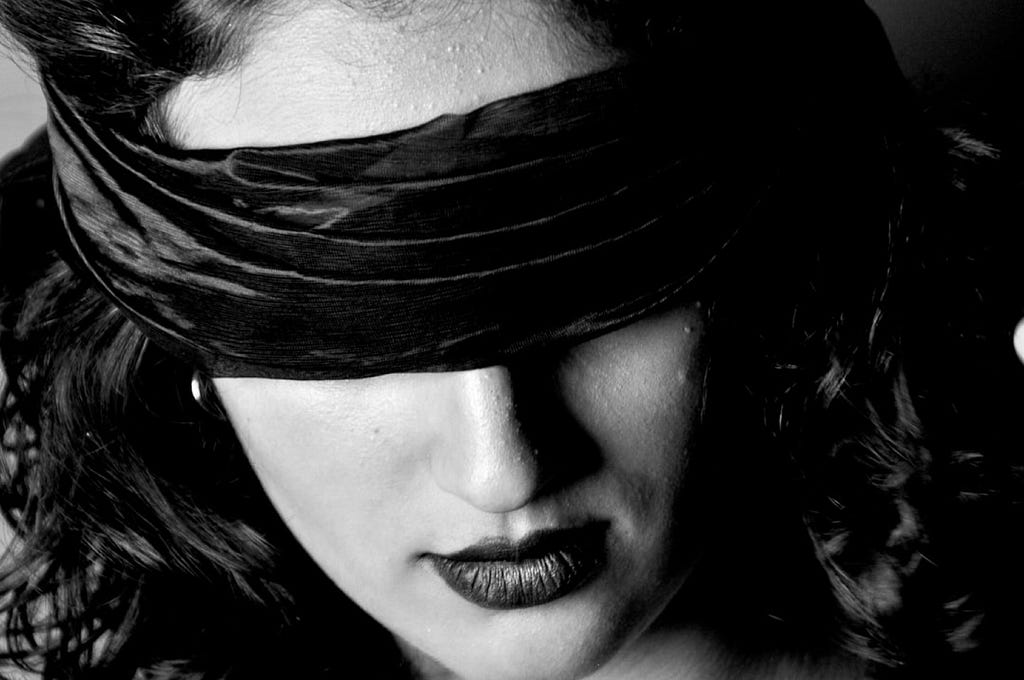 Emiliano Vittoriosi took this black- photo of a woman with a black blindfold over her eyes.