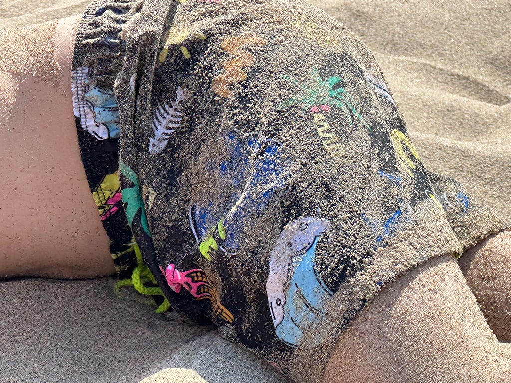 sand covered swim pant boy