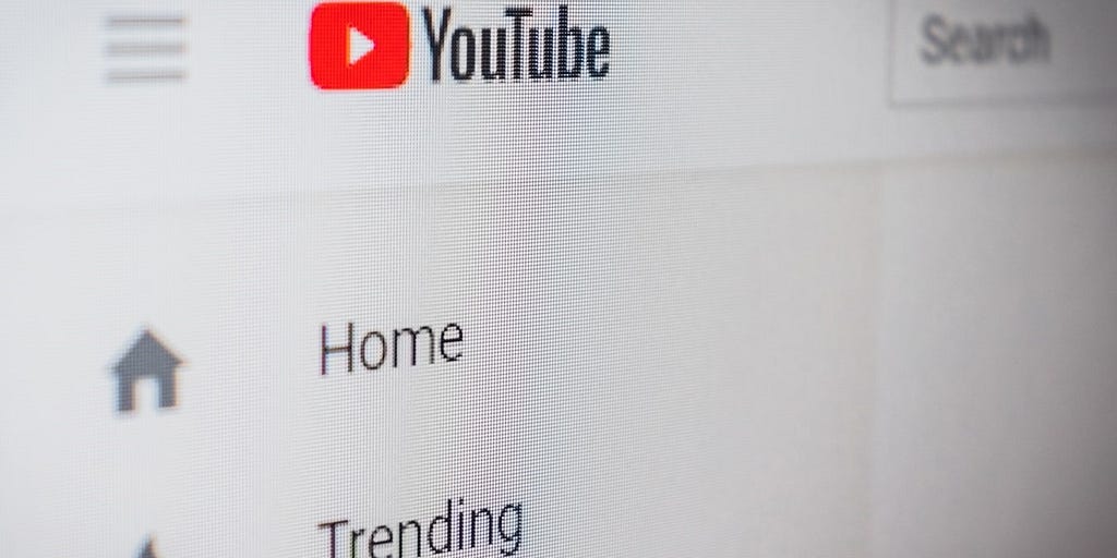 Close-up of YouTube’s landing page showing the YouTube logo as well as the “Home” and “Trending” buttons.