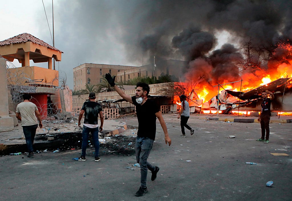 Protesters try to storm the governor’s building in Basra, Iraq, during protests demanding better public services and jobs, September 4, 2018. Photo by Nabil Al-Jurani/AP