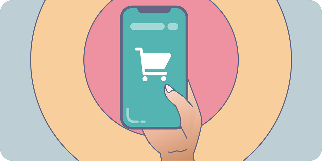 A hand holding an smartphone with a shopping cart icon on it