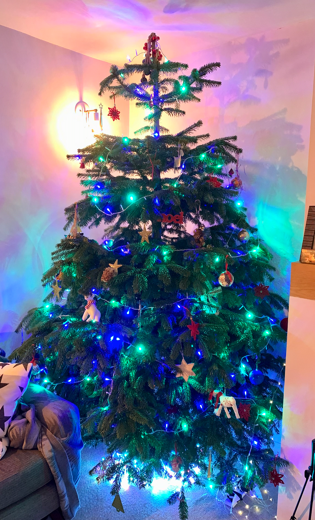 A Christmas tree with green and blue lights