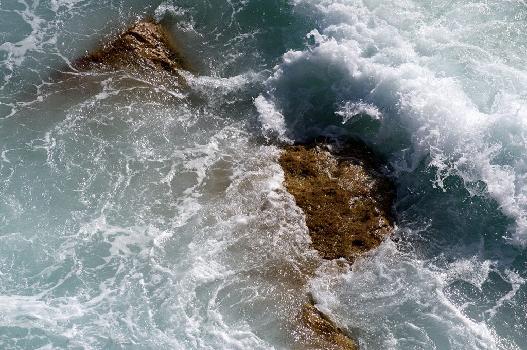 Photograph of waves on rocks, bird’s-eye view, at Bondi beach in Sydney, taken for healing by a medical doctor