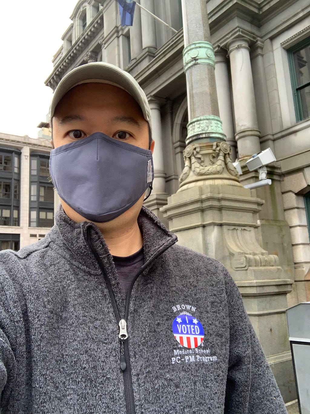 Janson Wu wearing a face mask and “I Voted” sticker