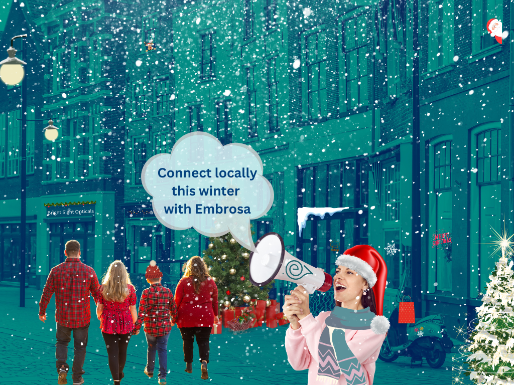 A joyful winter scene with a family dressed for the holidays captures the spirit of community connection that Embrosa supports. The woman in the Santa hat, cheerfully speaking into a megaphone, shows how Embrosa spreads brand stories hyper-locally using local reseller networks. The picture shows how Embrosa helps deliver brand messages and advertisements to local shoppers, mixing holiday fun with smart local marketing.