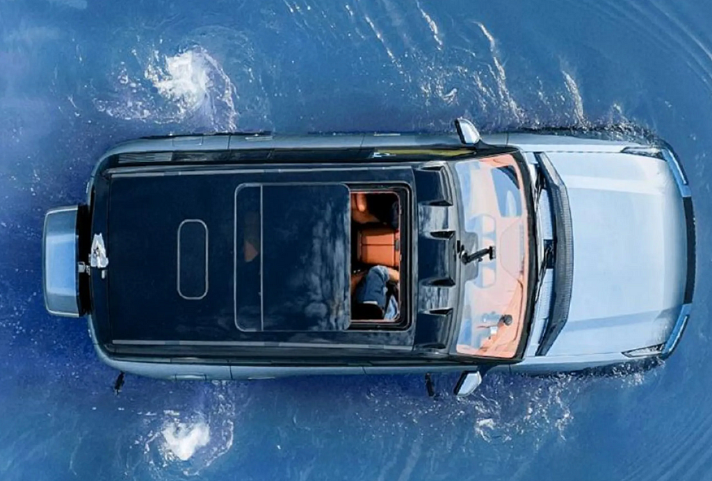 An aerial view of a car with a transparent roof driving through water, showcasing its floating or water-resistant capability.