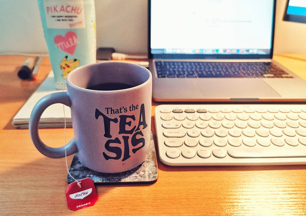 My desk, with a cup of tea, my pc and keyboard