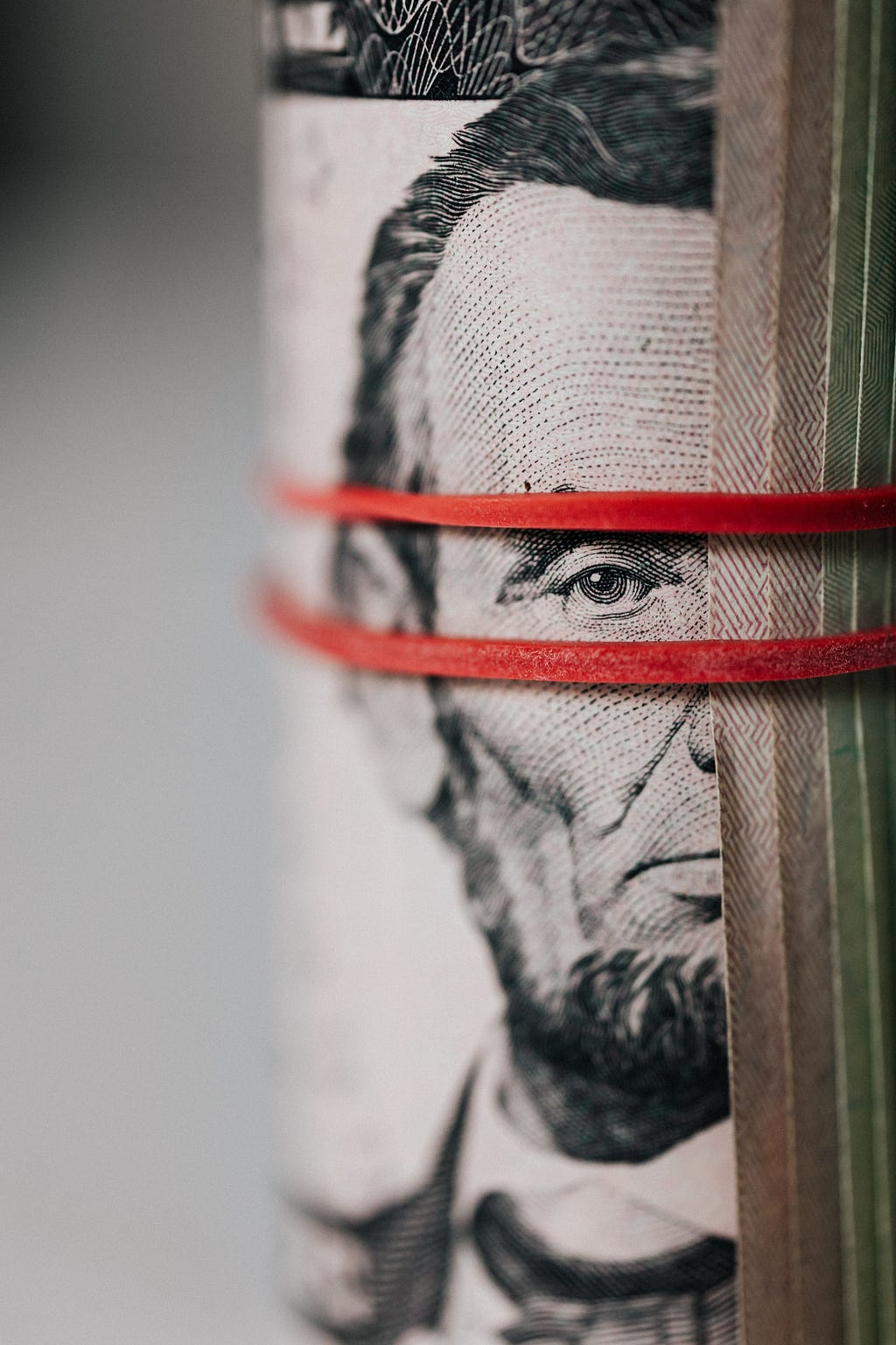Dollar bills with Abraham Lincoln’s face in focus