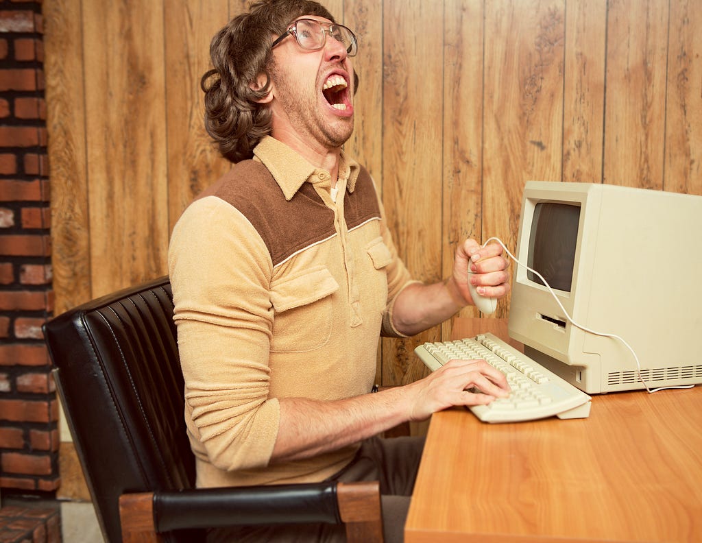 Image of a man who is frustrated with this computer.
