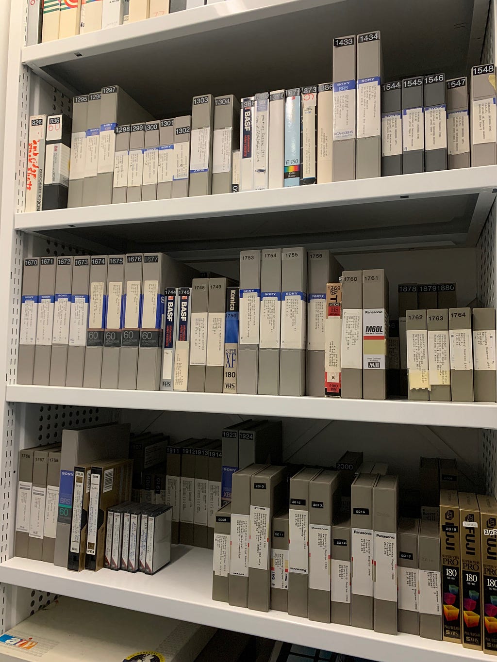 Shelves of videotapes and audiotapes in different sized boxes.