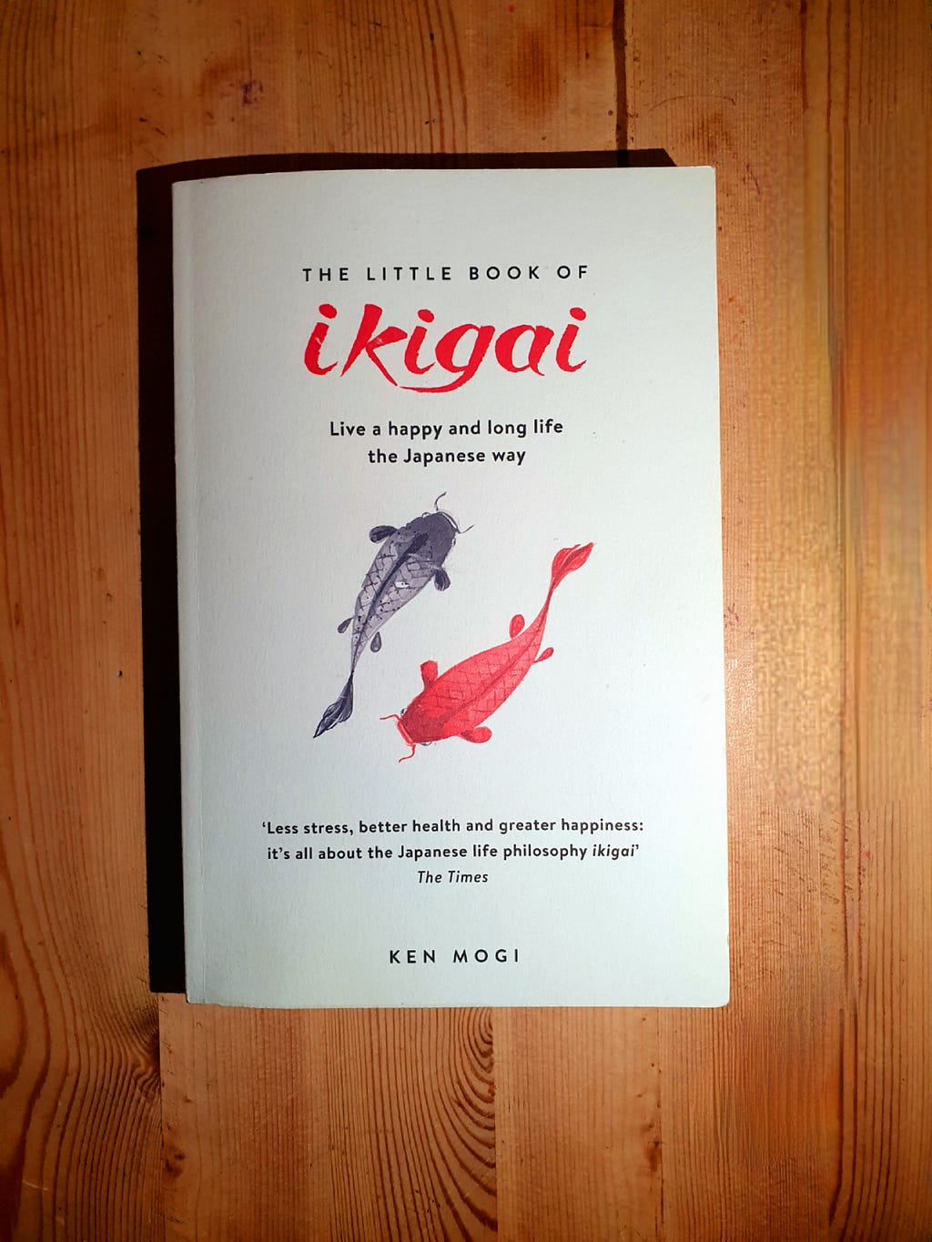 A copy of the book The Little Book of Ikigai on a simple wooden background. Edward Breen, 2023.