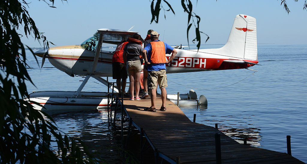Photo of a floatplane at the dock with people borading.