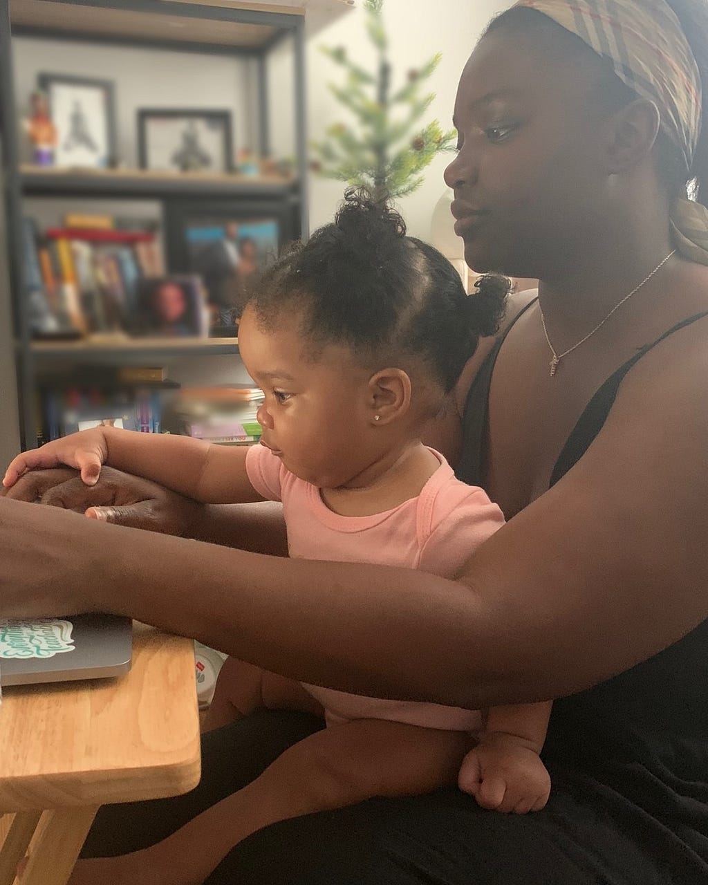 Kaivona and her one-year old daughter, Alaiah, working from home.