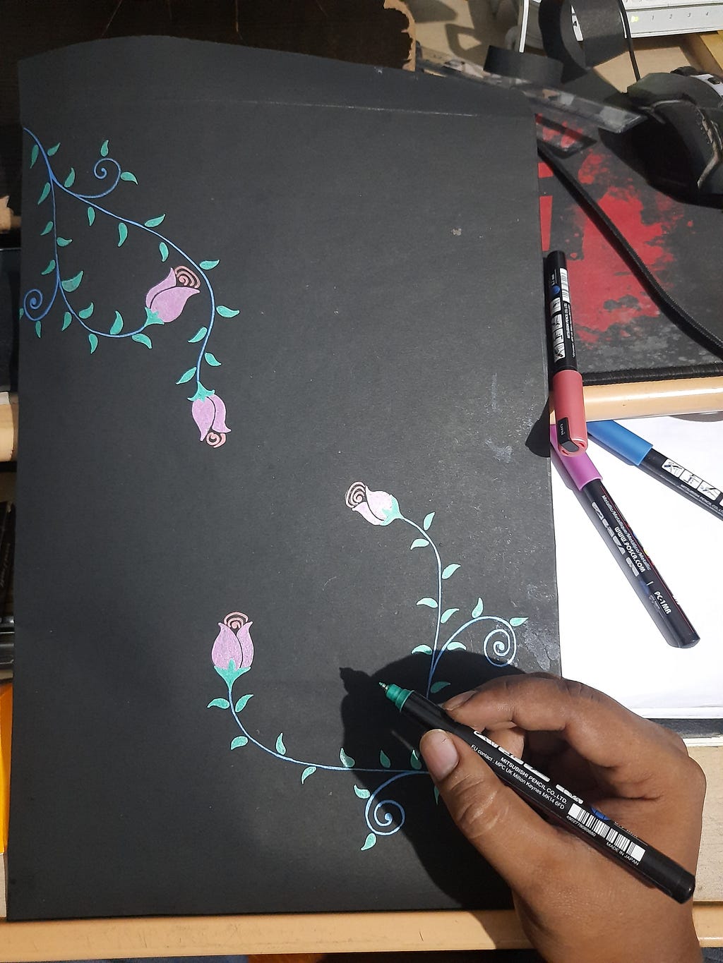 drawing on a black art paper with posca pen